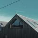 gray wooden house near body of water